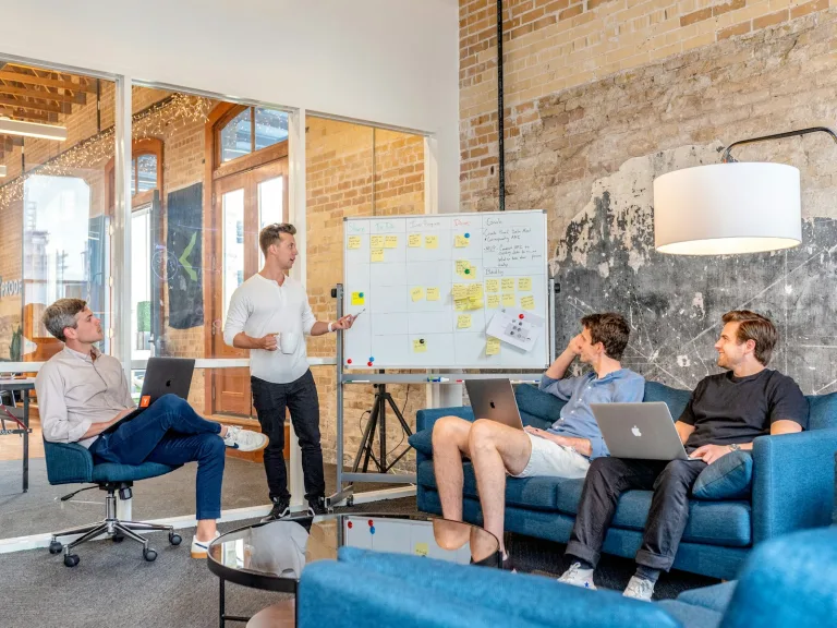 MLOps explained, illustrated by a team planning a system on a board