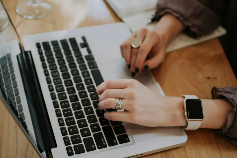 Writing a WordPress blog post with AI on a laptop keyboard